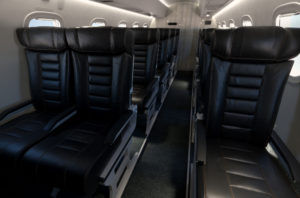 new united goderich - airplane aisle of black leather seats