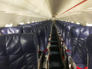 interior of red erj145 airliner with blue leather seats